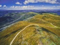 Aerial view of beautiful mountains and winding road on bright sunny day. Royalty Free Stock Photo