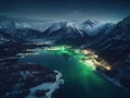 Aerial view of beautiful northern lake. Town lights by the lakeside.