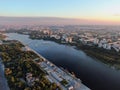 Aerial view beautiful panoramic cityscape at sunset. traffic of cars and passenger ships in the big city. drone shot Royalty Free Stock Photo