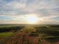 Aerial view beautiful panoramic landscape golden sunset above the forest. The road goes beyond the horizon in the rays of the sun Royalty Free Stock Photo