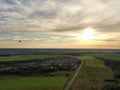 Aerial view beautiful panoramic landscape golden sunset above the forest. The road goes beyond the horizon in the rays of the sun Royalty Free Stock Photo