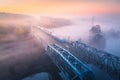 Aerial view of beautiful railroad bridge and river in fog in fall Royalty Free Stock Photo