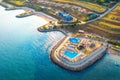 Aerial view of beautiful sandy beach and blue sea at sunset Royalty Free Stock Photo