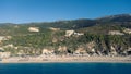 Aerial view of beautiful sandy beach with sunshades and soft turquoise ocean wave. Tropical sea in summer season on Kathisma beach Royalty Free Stock Photo