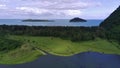 Aerial view of beautiful savannah, pond and beautiful beach with pine trees in babah Ie village in Aceh Jaya, Indonesia.