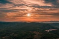 Aerial view of the beautiful soft sunset over the green hills Royalty Free Stock Photo