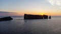 Aerial view of a beautiful sunrise on Perce rock, Gaspe peninsula. Sailboat near the rock Royalty Free Stock Photo