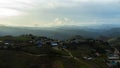 Aerial view of beautiful sunrise or sunset sky and rural villages. Village landscape in misty valley and mountain clouds in Royalty Free Stock Photo