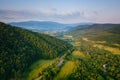 Aerial view of the beautiful wooded Carpathian mountains and small village, summer landscape