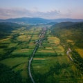 Aerial view of the beautiful wooded Carpathian mountains and small village, summer landscape Royalty Free Stock Photo