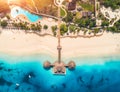 Aerial view of beautiful wooden hotel in Indian ocean at sunset