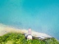 Aerial view of beautiful wooden pier, sea or lake bay, sandy beach at sunset in summer. Top view of jetty, transparent Royalty Free Stock Photo