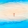 Aerial view of the beautiful young lying woman on the sandy beach