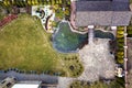 Aerial view of beautifully landscaped property complex. Roofs of recreation house cottage, pond in ecological area on bright sunny Royalty Free Stock Photo