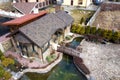 Aerial view of beautifully landscaped recreation house cottage complex with pond in ecological area on bright sunny day. Modern Royalty Free Stock Photo