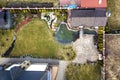 Aerial view of beautifully landscaped recreation house cottage complex with pond in ecological area on bright sunny day. Modern Royalty Free Stock Photo