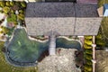 Aerial view of beautifully landscaped recreation house cottage complex with pond in ecological area on bright sunny day. Modern Royalty Free Stock Photo