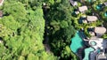 Aerial view of beautifully landscaped recreation house cottage complex with pond in ecological area on bright sunny day Royalty Free Stock Photo