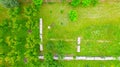 Aerial view of beekeeper as he mowing a lawn in his apiary with a petrol lawn mower Royalty Free Stock Photo