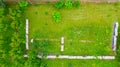 Aerial view of beekeeper as he mowing a lawn in his apiary with a petrol lawn mower Royalty Free Stock Photo