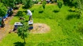 Aerial view of beekeeper as he mowing a lawn in his apiary with a petrol lawn mower Royalty Free Stock Photo