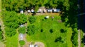 Aerial view of beekeeper as he mowing a lawn in his apiary with a petrol lawn mower Royalty Free Stock Photo