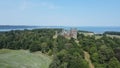 Aerial view of the Belvoir Castle on the seashore with a blue sky in the background, United Kingdom