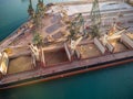 Aerial view of big cargo ship bulk carrier is loaded with grain of wheat in port at sunset Royalty Free Stock Photo