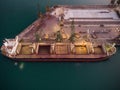 Aerial view of big cargo ship bulk carrier is loaded with grain of wheat in port at sunset Royalty Free Stock Photo