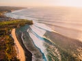 Aerial view of big stormy waves at warm sunset and beach. Biggest ocean wave in Bali Royalty Free Stock Photo