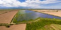 Aerial view of big sustainable electric power plant with many rows of solar photovoltaic panels for producing clean