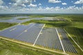 Aerial view of big sustainable electric power plant with many rows of solar photovoltaic panels for producing clean