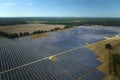 Aerial view of big sustainable electric power plant with many rows of solar photovoltaic panels for producing clean