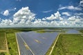 Aerial view of big sustainable electric power plant with many rows of solar photovoltaic panels for producing clean