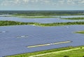 Aerial view of big sustainable electric power plant with many rows of solar photovoltaic panels for producing clean