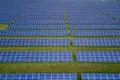 Aerial view of big sustainable electric power plant with many rows of solar photovoltaic panels for producing clean