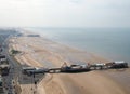 Aerial view of blackpool looking north showing the beach at low tide with famous piers and the roads and buildings of the town str