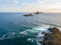 Aerial view of the Bloods Islands and Lighthouse, Corsica, France: rocks, waves and sailboat