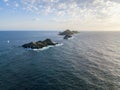 Aerial view of the Bloods Islands and Lighthouse, Corsica, France: rocks, waves and sailboat
