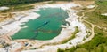 Aerial view of a blue-green quarry pond for quartz sand in Germany with the suction dredger and the conveyor belt for the sand,