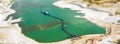 Aerial view of a blue-green quarry pond for quartz sand in Germany with the suction dredger and the conveyor belt for the sand,