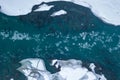 Aerial of a blue and green river with snow and crushed ice during an ice drift in winter in the Altai mountains in Russia Royalty Free Stock Photo