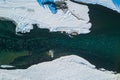 Aerial of a blue and green river with snow and crushed ice during an ice drift in winter in the Altai mountains in Russia Royalty Free Stock Photo