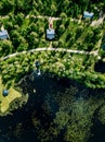 Aerial view of blue lake with green forests in Finland. Wooden house, sauna, boats and fishing pier by the lake Royalty Free Stock Photo