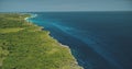 Aerial view of blue ocean bay at green tropic landscape. Greenery grass valley at cliff sea shore Royalty Free Stock Photo