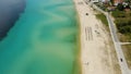 Aerial view of a blue ocean near a cliffy shore at daytime