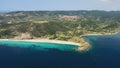 Aerial view of a blue ocean near a cliffy shore at daytime