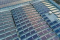 Aerial view of blue photovoltaic solar panels mounted on industrial building roof for producing green ecological Royalty Free Stock Photo