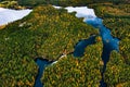 Aerial view of blue rivers and lakes in beautiful orange and red autumn forest, Finland Royalty Free Stock Photo