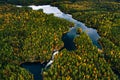 Aerial view of blue rivers and lakes in beautiful orange and red autumn forest, Finland Royalty Free Stock Photo